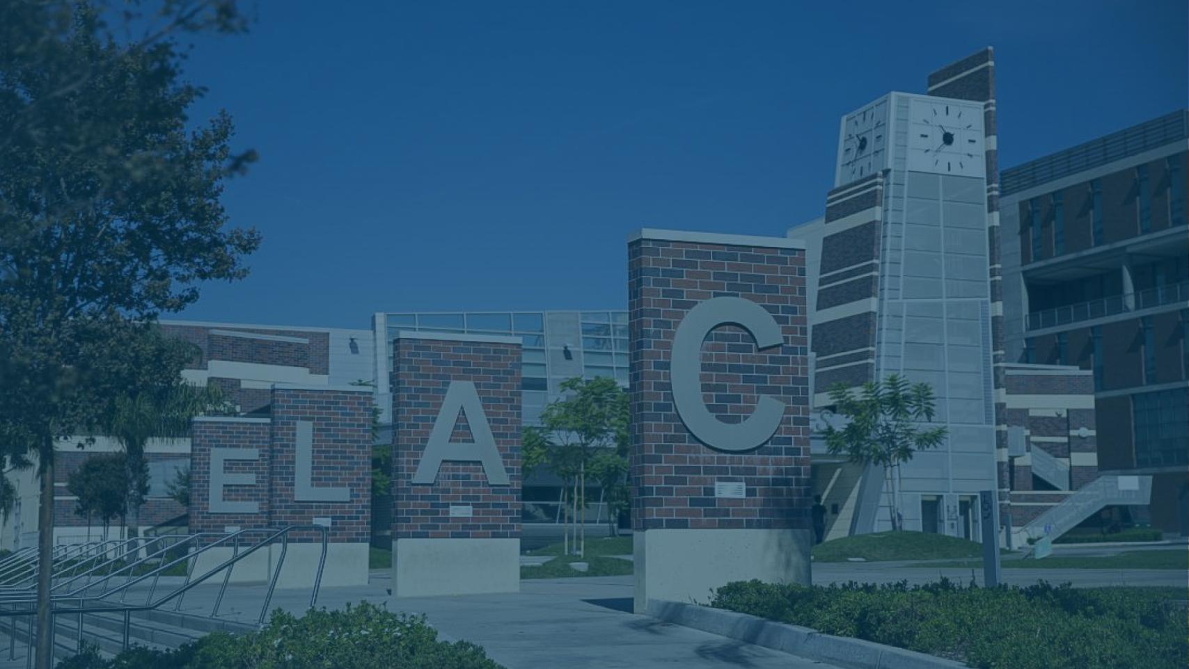 Letter signs spell "ELAC" on a college campus.