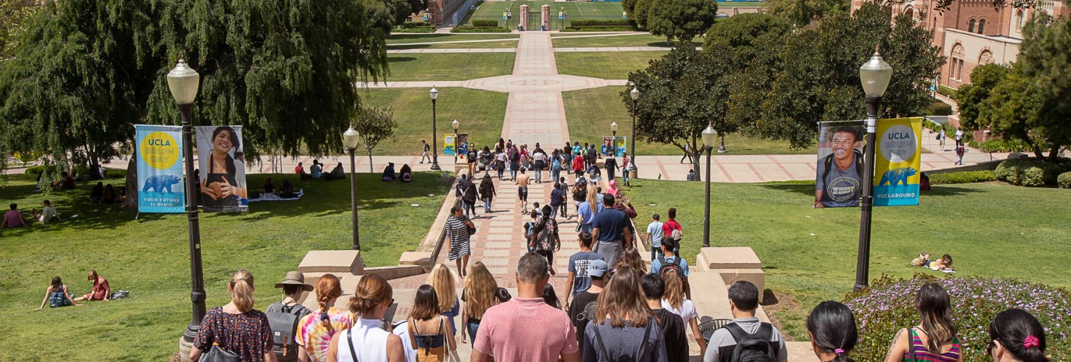 Students walk up and down an outdoor staircase.