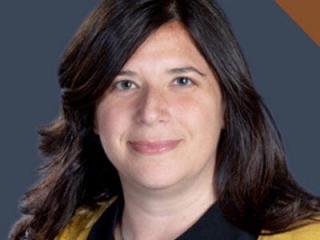 Headshot of woman with straight brown hair smiling.